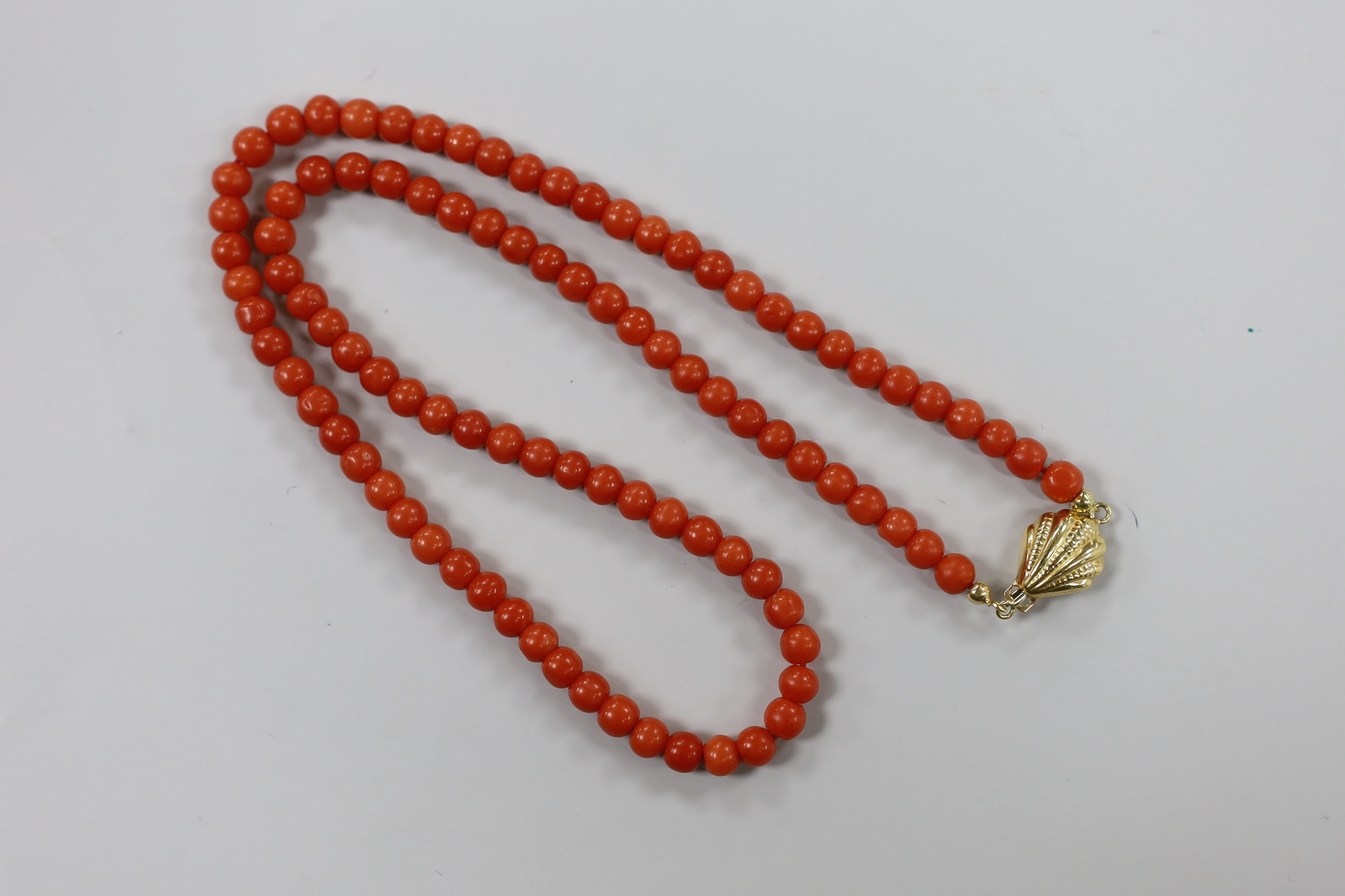 A single strand coral bead necklace, with 750 yellow metal clasp, 46cm.